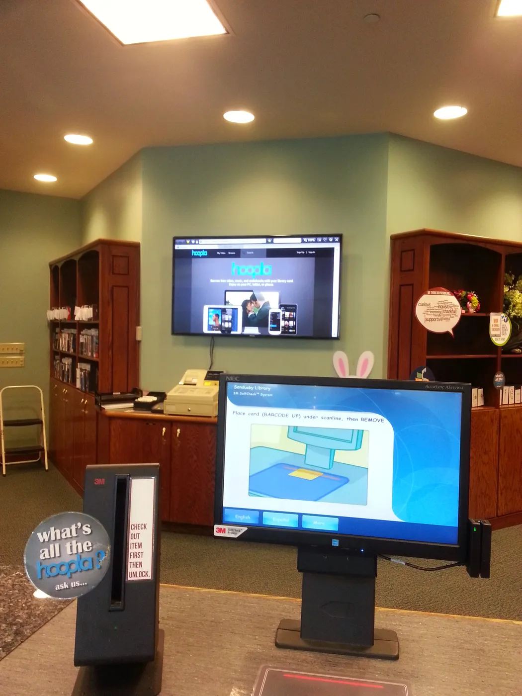 Self-checkout kiosk and a Hoopla screen at Sandusky Library in 2014